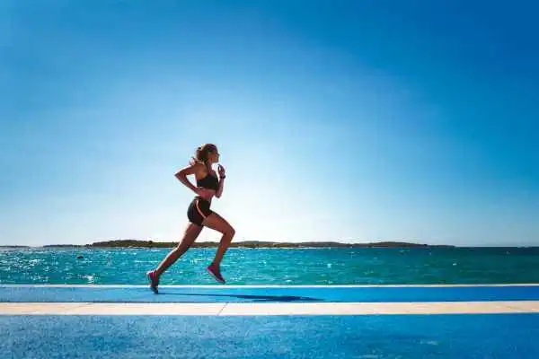 Woman running showing strong leg muscle Hampton
